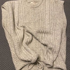 Sweater vest with tie at bottom